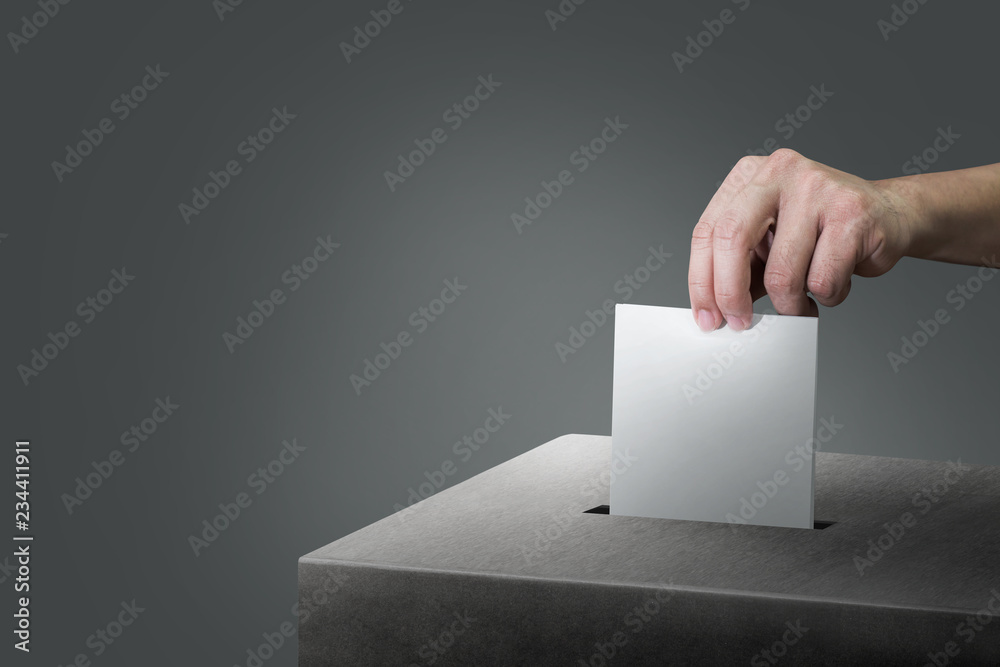 Hand holding ballot paper for election vote at place election background. Election vote concept.