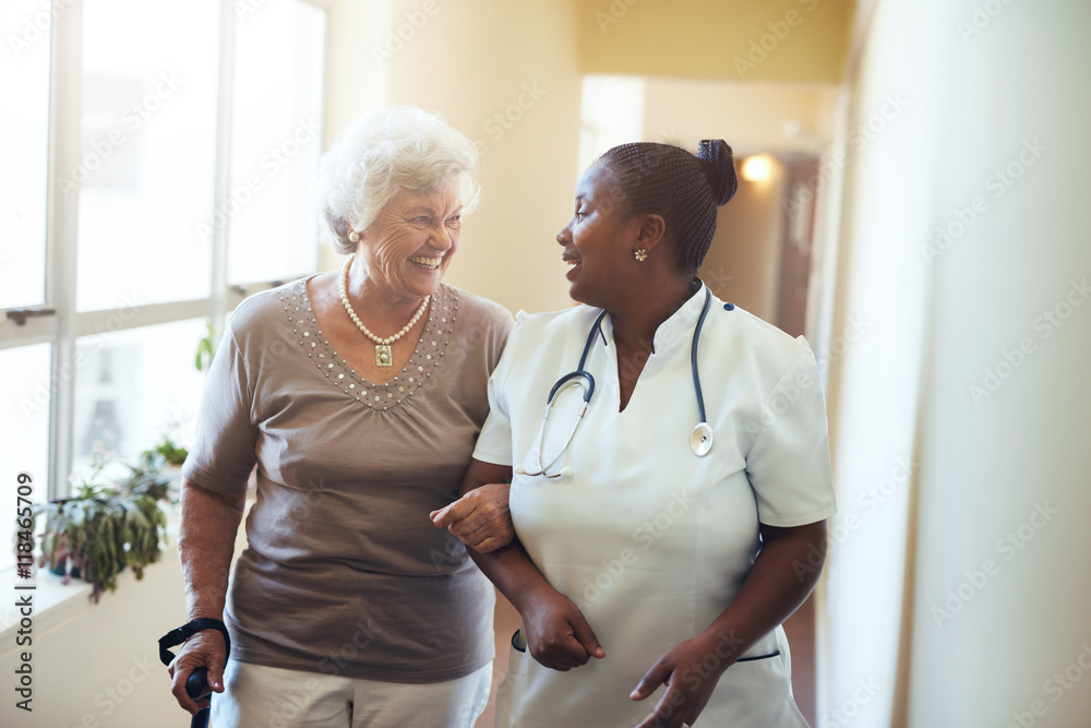 Nurse assisting senior woman at nursing home