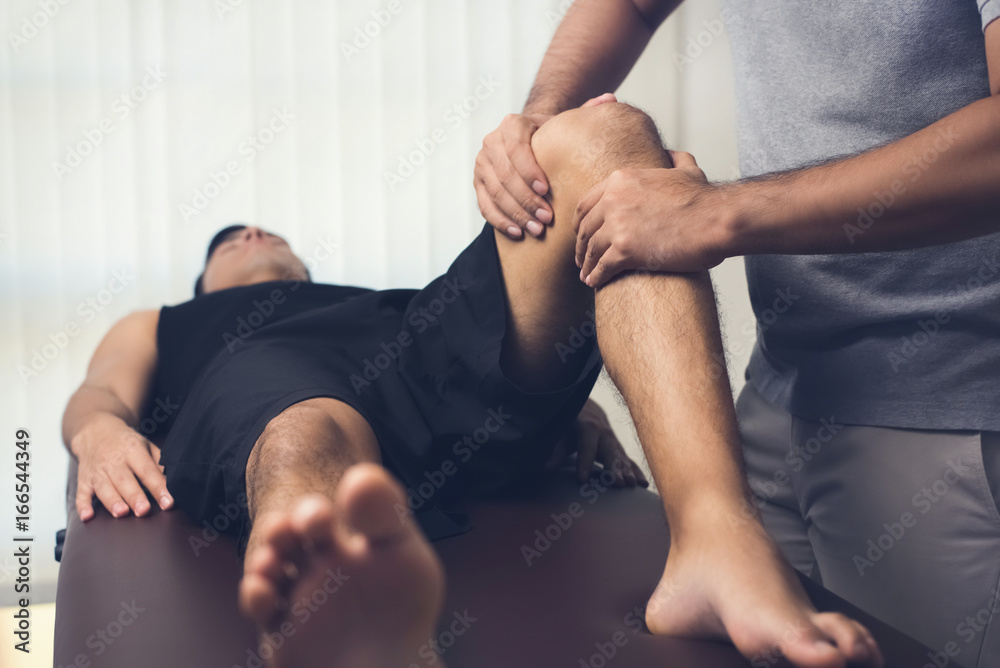 Physiotherapist treating athlete male patient