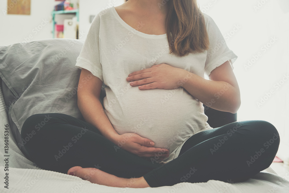 Pregnant woman touching her belly